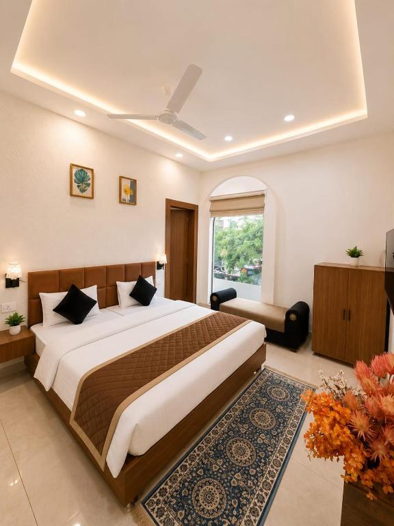 a bedroom with a large bed and a window at Megh hotel in Gangānagar