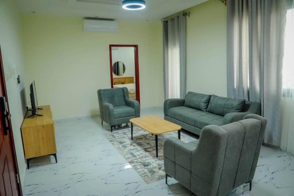 a living room with a couch and two chairs and a tv at Star home Tower in Mogadishu