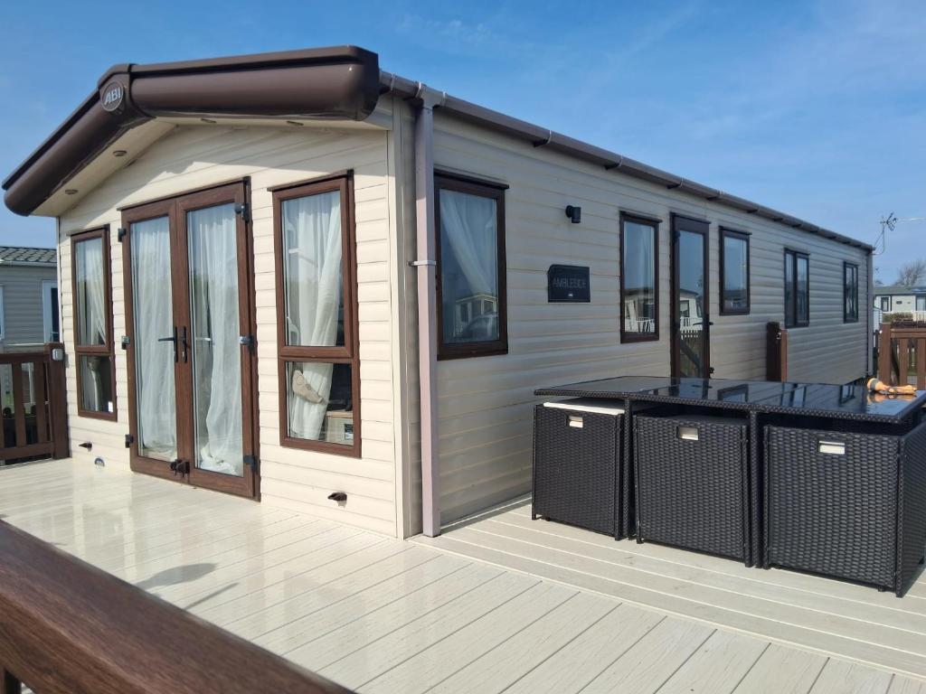 a tiny house on a deck with a solarium at A21 Unity Beach, Brean in Brean