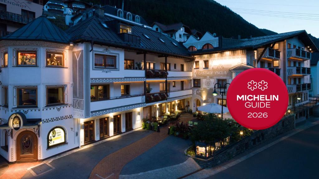 a building with a red sign in front of it at Superior Gourmethotel Yscla in Ischgl