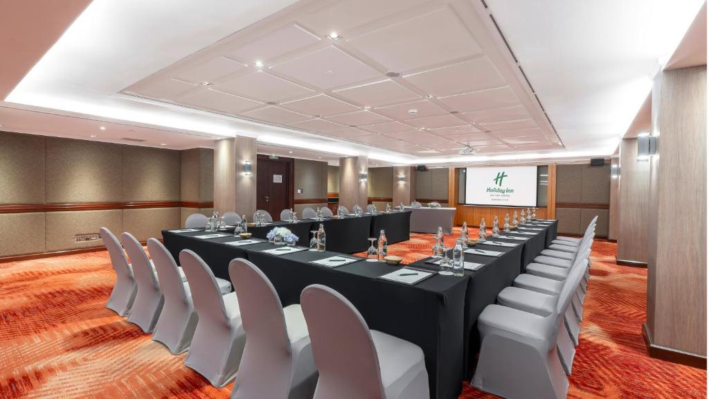 A large conference room arranged around a long central table.