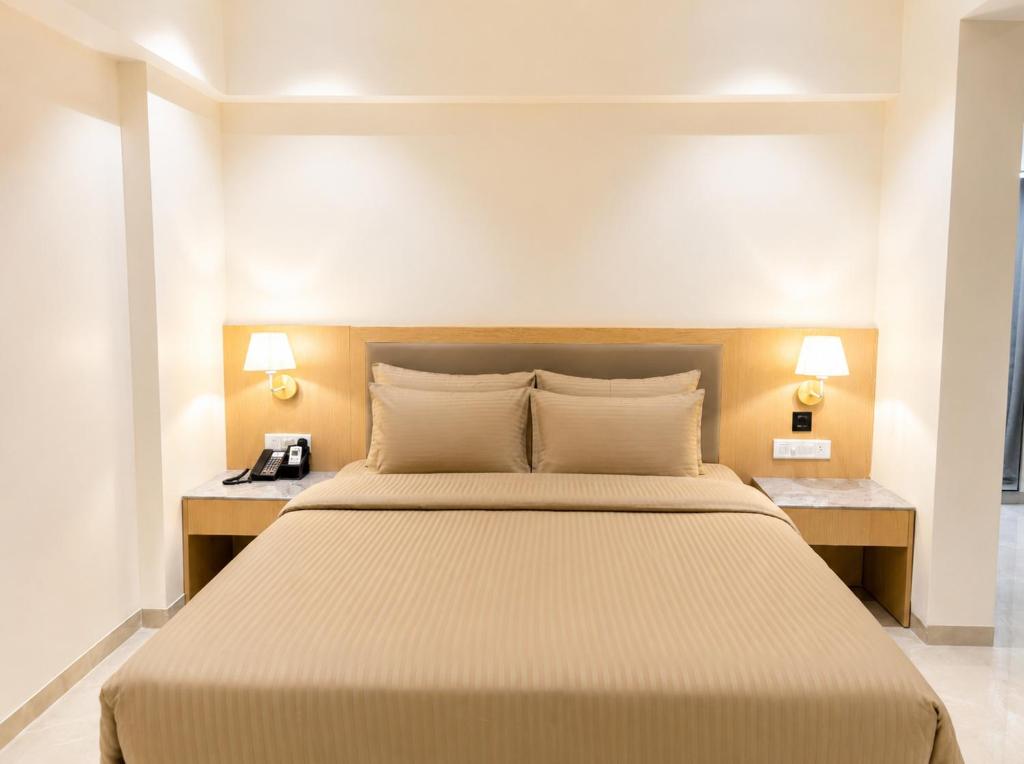 a bedroom with a large bed with two night stands at The Zenith Luxuary in Patna