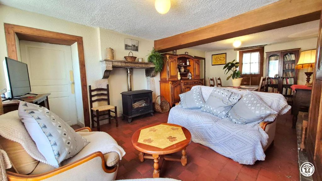 a living room with two couches and a fireplace at Georgeluc in Langeron