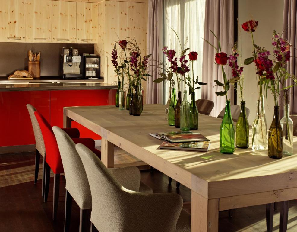 a dining room table with vases of flowers on it at HYPERION Hotel Dresden Am Schloss in Dresden