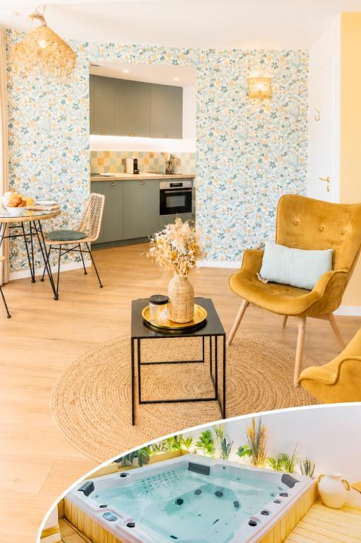 a living room with a coffee table and a kitchen at Appart'Hôtel & Spa "Les Voiles" Le Groix in Carnac