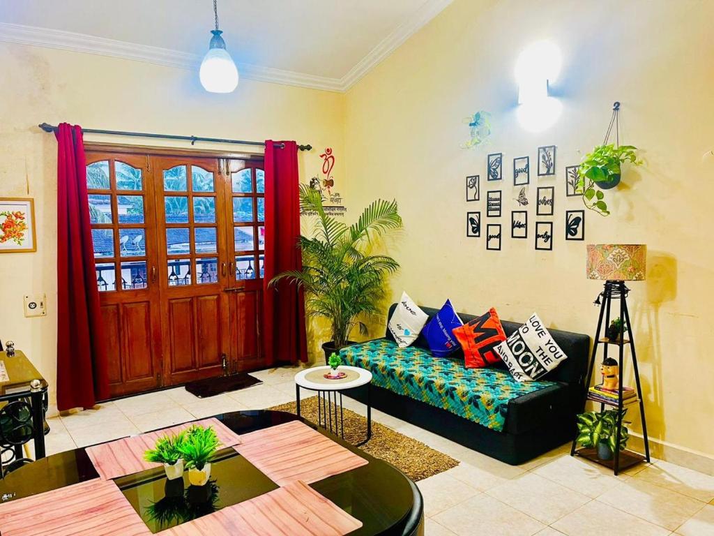 a living room with a couch and a table at Harmony Vista in Calangute