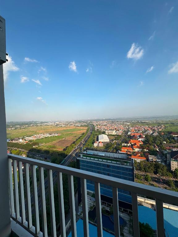 a view of a city from the balcony of a building at Apartemen Gresik in Panggang