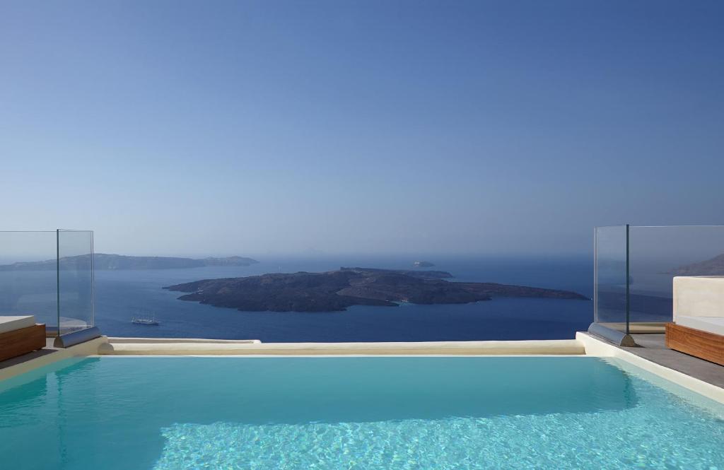 a swimming pool with a view of the ocean at Istoria, a Member of Design Hotels in Perivolos