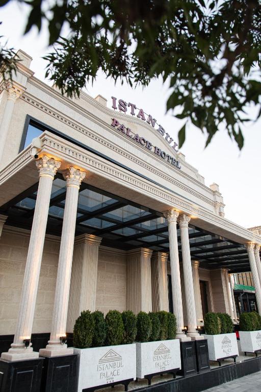 a large building with columns in front of it at Istanbul Palace Hotel in Urganch
