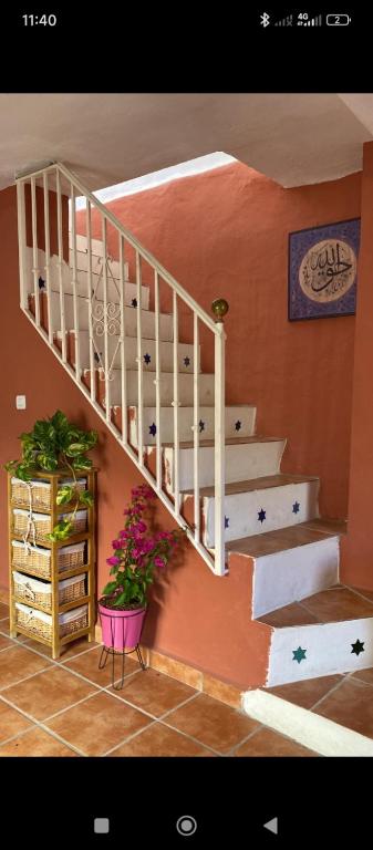 a white staircase in a room with plants at Casa Aire del Sur in Órgiva