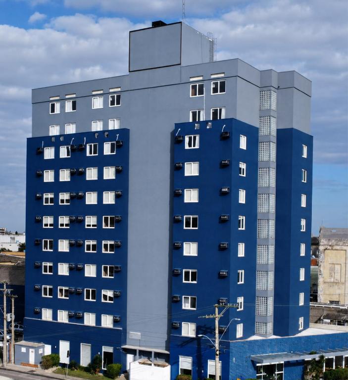 a blue apartment building with a blue at Swan Rio Grande in Rio Grande