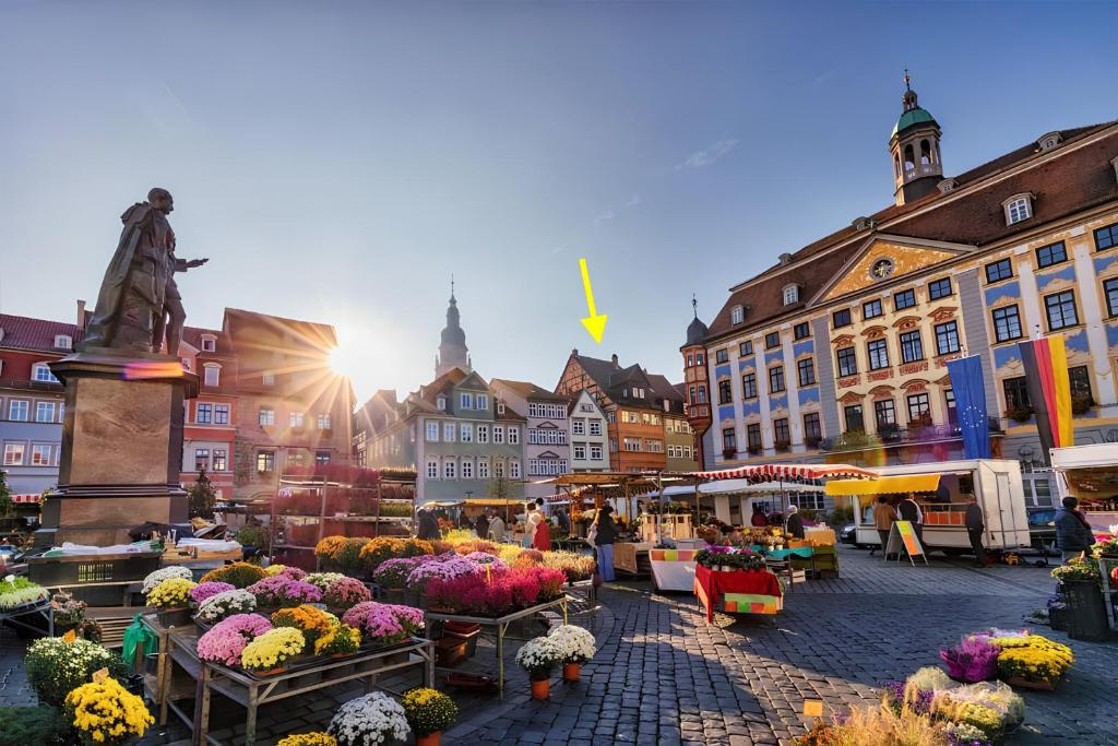 a market in a city with flowers on display at The Square Coburg in Coburg