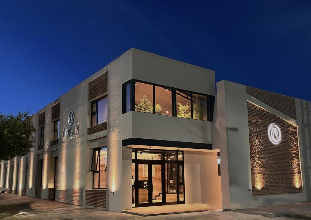 a large white building with a lot of windows at Origen Patagonia Hotel in Puerto San Julián