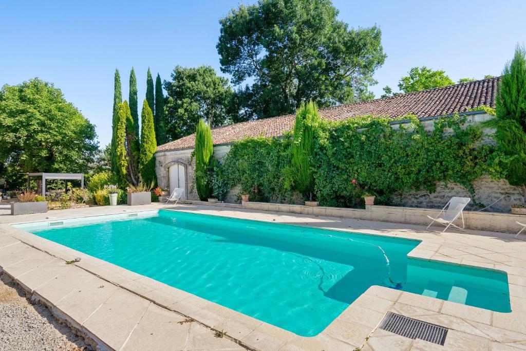 a swimming pool in the backyard of a house at Domaine De La Perthuiserie in Saint-Porchaire