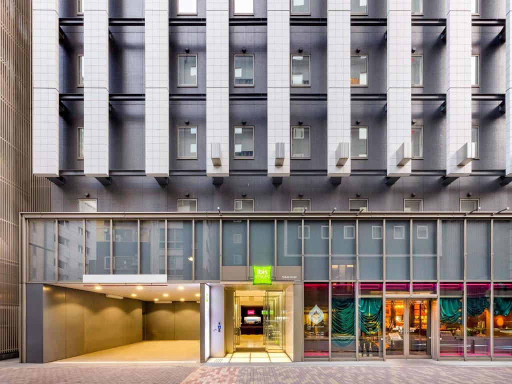 an external view of a building with a revolving door at ibis Styles Tokyo Ginza in Tokyo