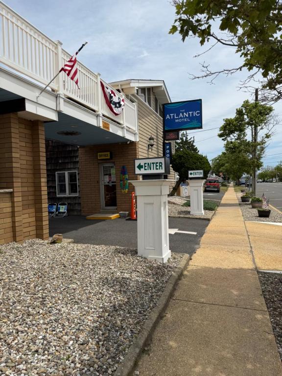 a building with an american flag next to a street at Atlantic Motel in Point Pleasant Beach
