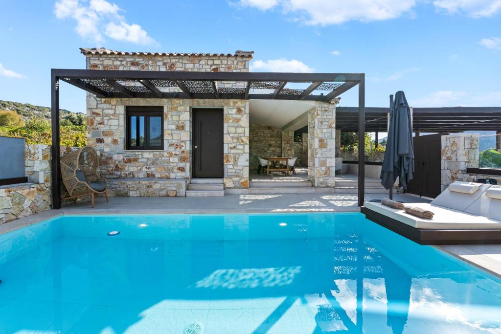 a villa with a swimming pool and a house at Ιπποθόη in Meganisi