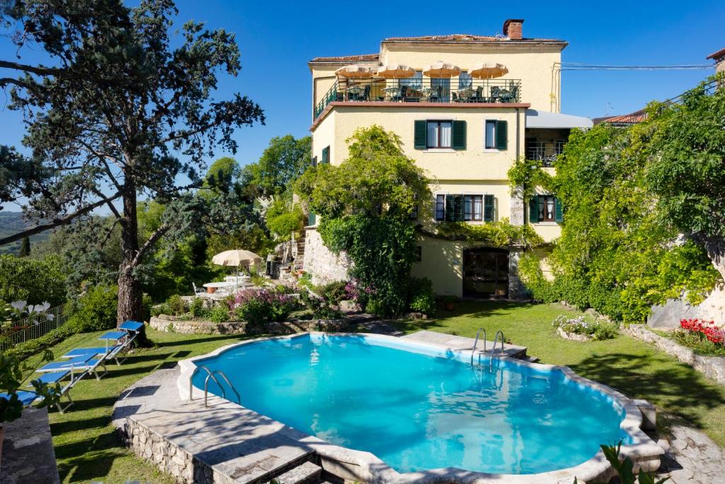 a house with a swimming pool in front of it at B&B Villa Clodia in Saturnia