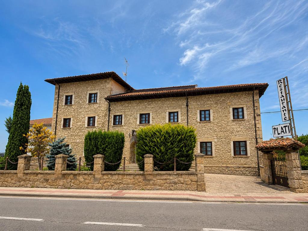 a large brick building on the side of a street at Hotel Restaurante Plati in Villarcayo