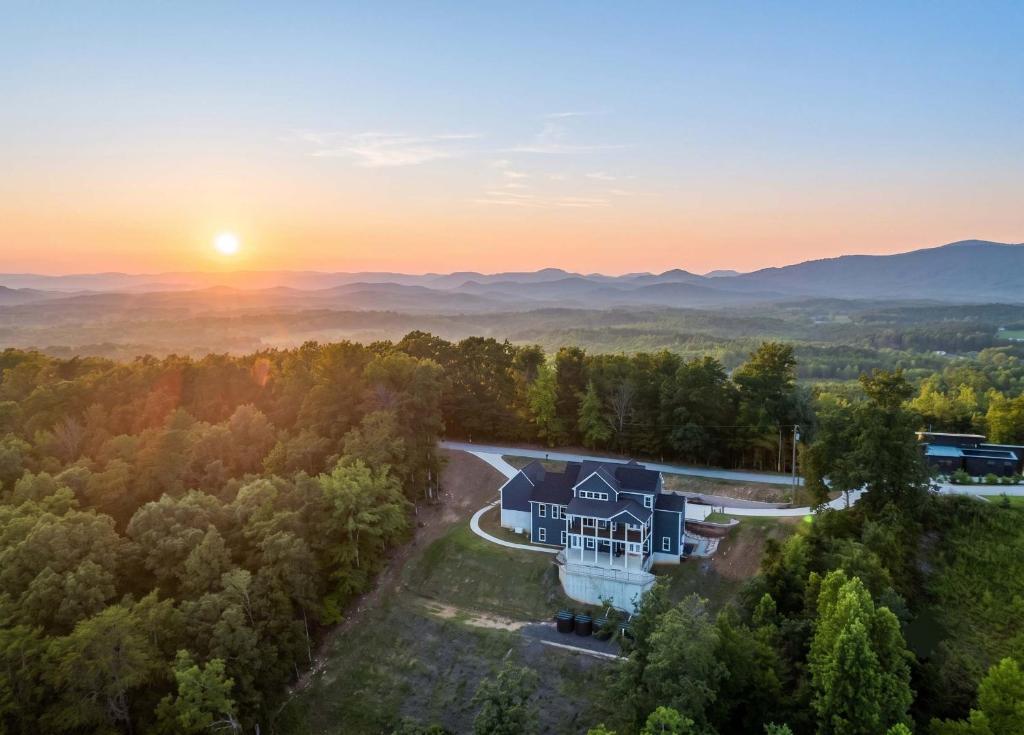 an aerial view of a house on a hill with the sunset in the background at Mountain View Escape in Taylors