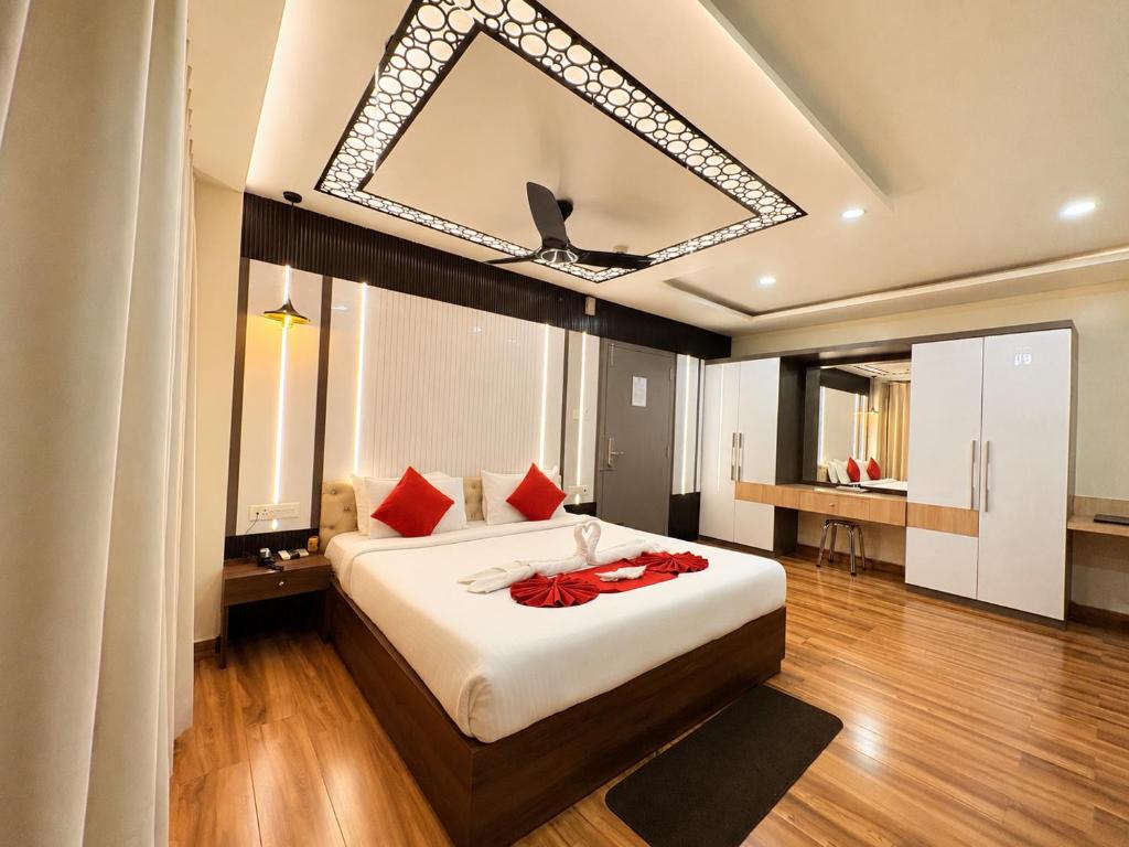 a bedroom with a large white bed with red pillows at Durene Beach Resort - New Premium Resort In Baliapanda - Restaurant - Beach - Parking in Puri