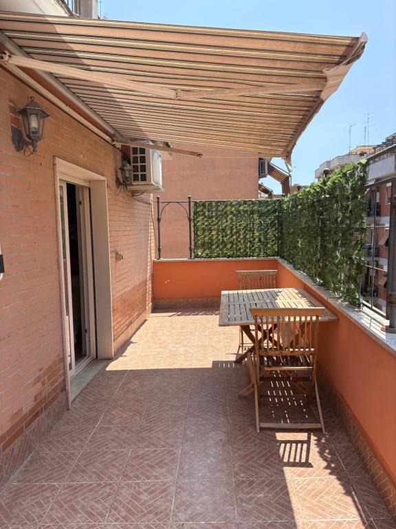 a patio with a table and chairs on a balcony at La Terrazza in Civitavecchia
