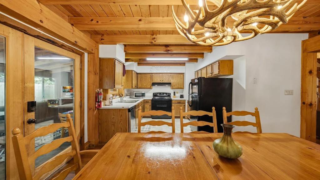 a kitchen with a wooden table and a chandelier at Hillside Hideaway in Sevierville