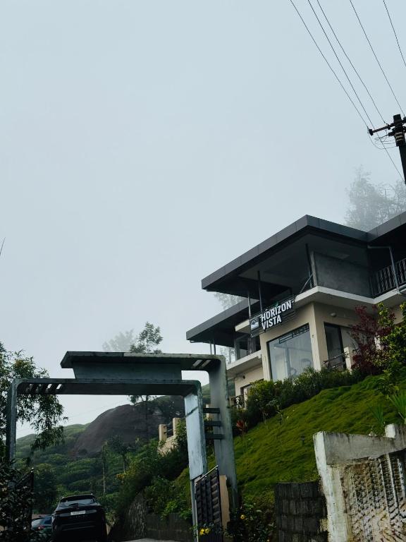 a gas station with a car parked in front of it at Horizon Vista in Vālpārai