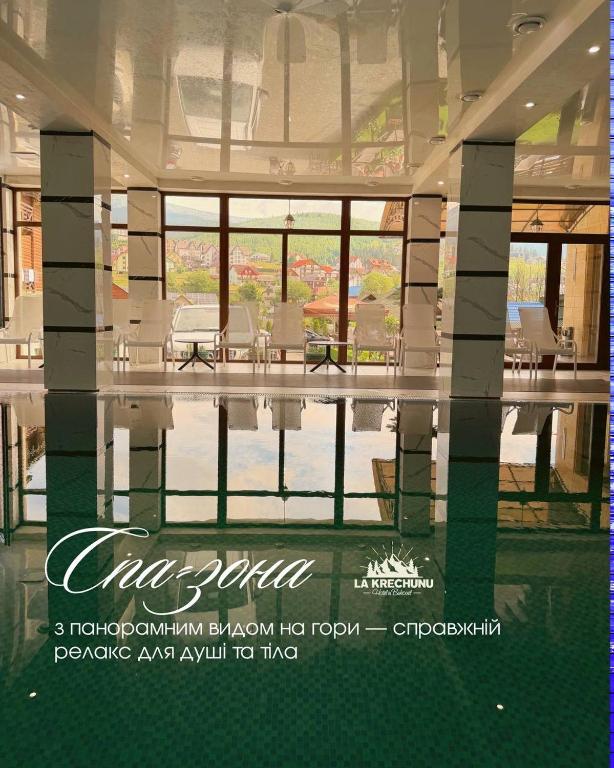 a picture of a swimming pool in a house at La Кrechunu in Bukovel