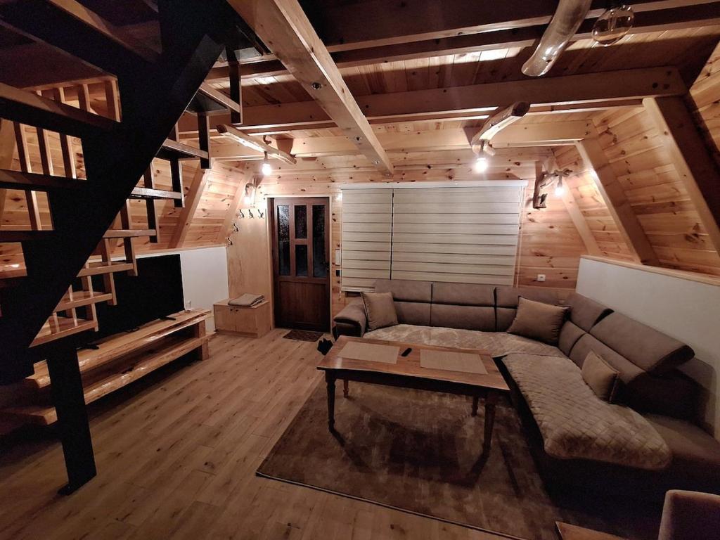 a living room with a couch and a table at Koliba SAN in Žabljak