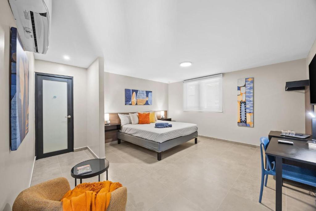a bedroom with a bed and a desk in a room at Ocean Breeze in San Juan
