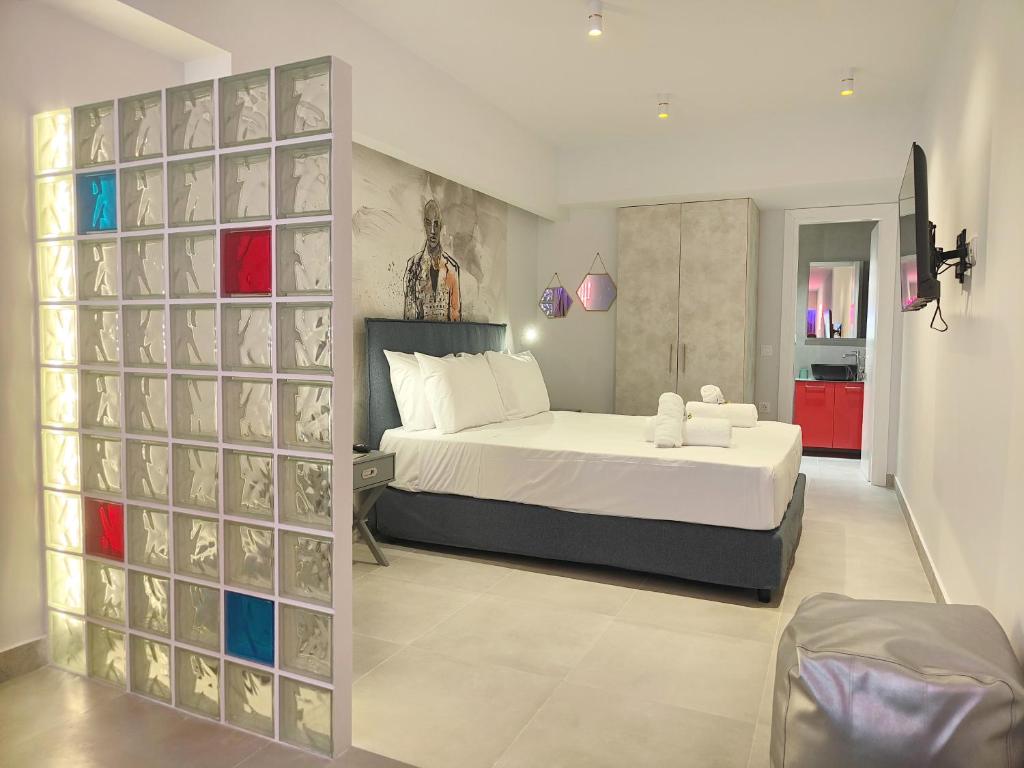 a bedroom with a bed and a wall with glass blocks at CORFU INDUSTRIAL Studios in Corfu
