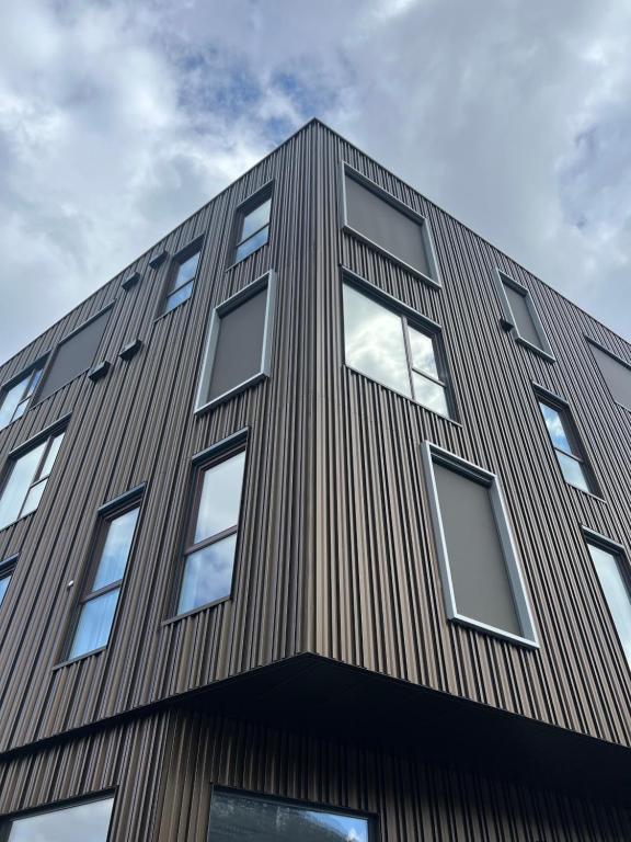 a tall building with windows on top of it at Skudeløken Apartment Hotel in Førde