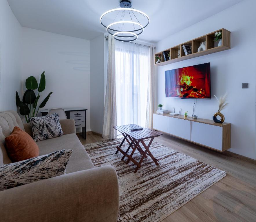 a living room with a couch and a table at 1 bedroom unit with a sunrise view in Tatu City
