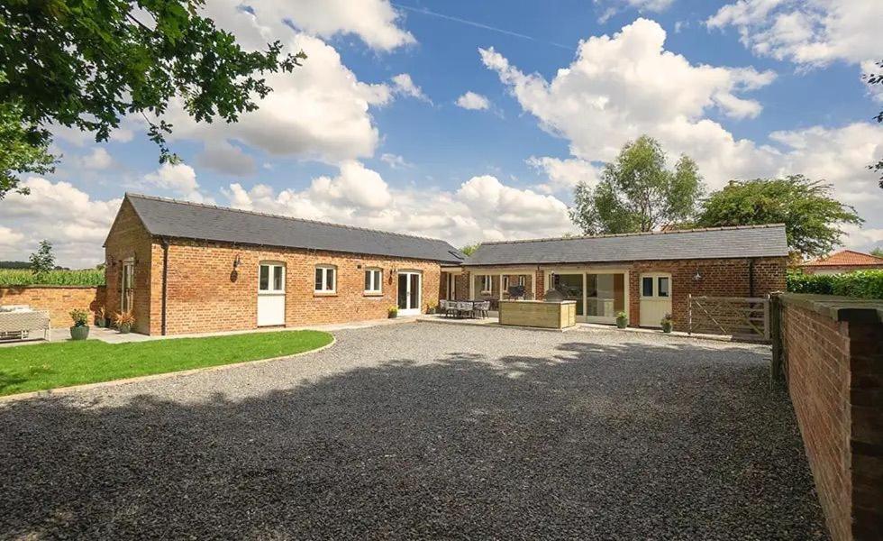 a brick house with a driveway in front of it at Bluebell in Edlington