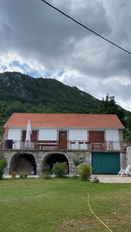 a building with a balcony on top of a field at Vrela vacation in Vrela