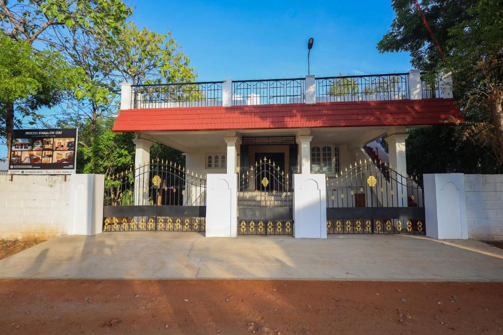 a house with a balcony on top of it at Princess Bungalow Stay Madurai in Tirupparangunram