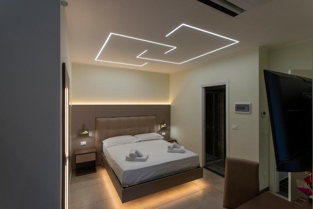 a bedroom with a bed and a television in it at The Reserve by Vulcano in Mirto