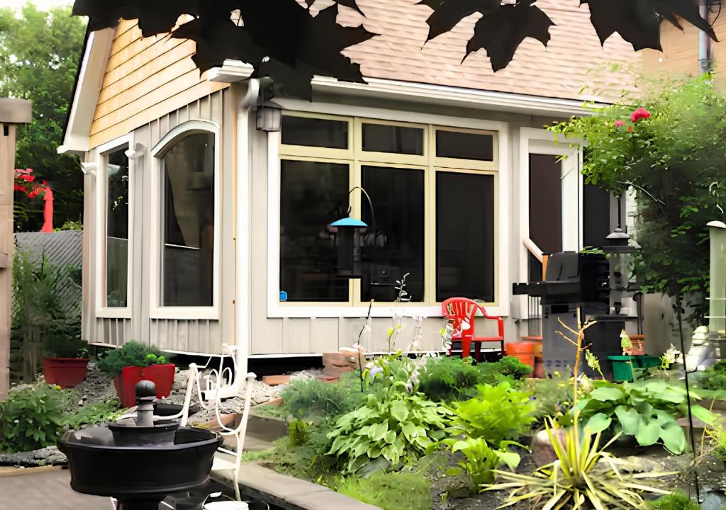 a small house with a garden in front of it at Peterborough Zen Retreat in Peterborough