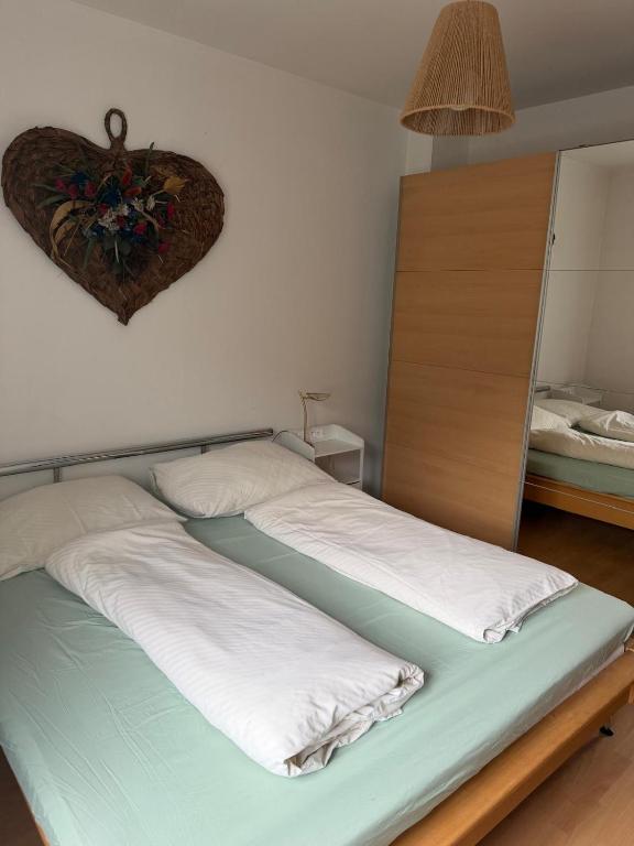 a bedroom with two beds with a heart on the wall at Wohnhaus Leitner in Wald am Schoberpaß