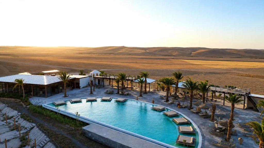 an overhead view of a swimming pool in the desert at Sunset Agafay Resort in El Karia