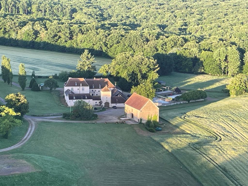 an aerial view of a large house on a field at Bambi in Asquins