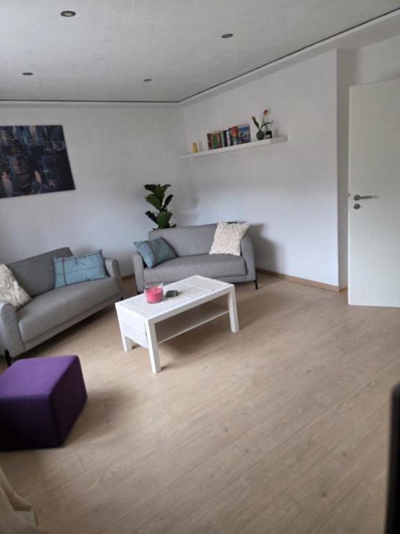 a living room with a couch and a table at Ferienwohnung Nele in Heimbach