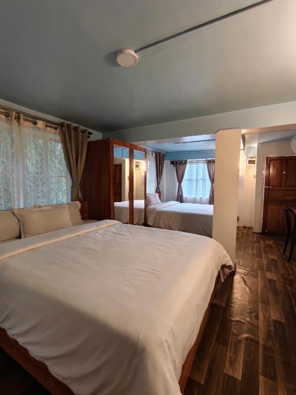 a bedroom with two large beds in it at Spring Grove B&B in Jowai