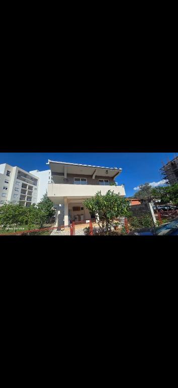 a large white building with trees in front of it at Apartmani Seki in Bar