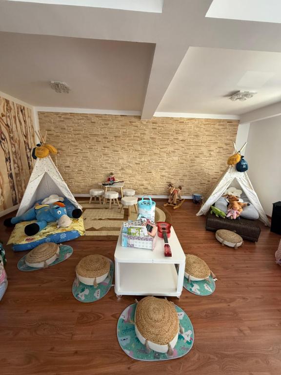 a living room with two tents and a table at Harmony House Vera Lux in Dragomireşti