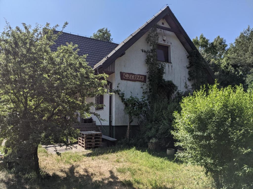 an old house with a sign on the side of it at Czerpak in Małszewko