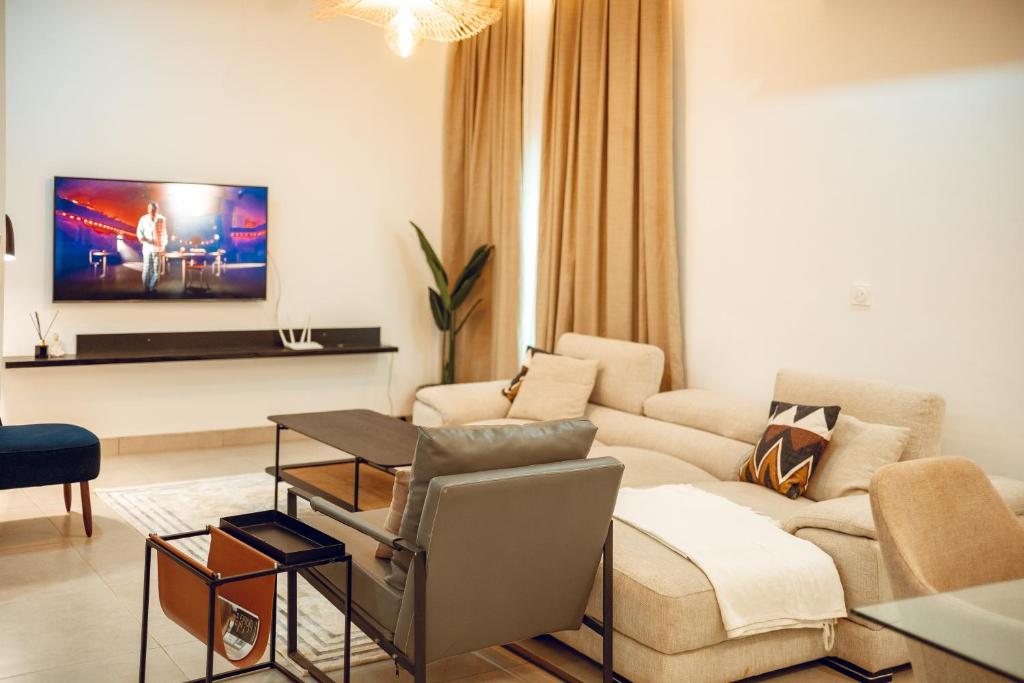 a living room with a couch and a table at Résidence Daana in Komé