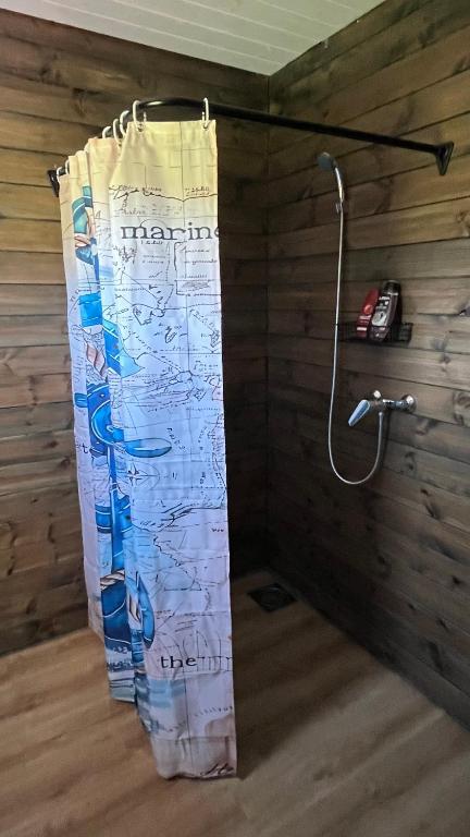 a shower in a room with a shower curtain at Peipsi Village Sofia in Kasepää
