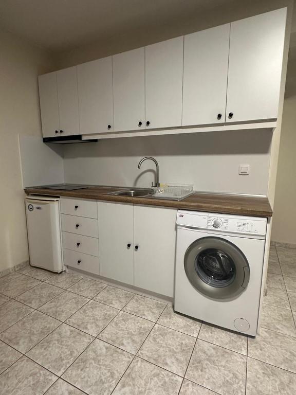 a kitchen with a washing machine and a sink at Bluesky Apartment AXD in Alexandroupoli